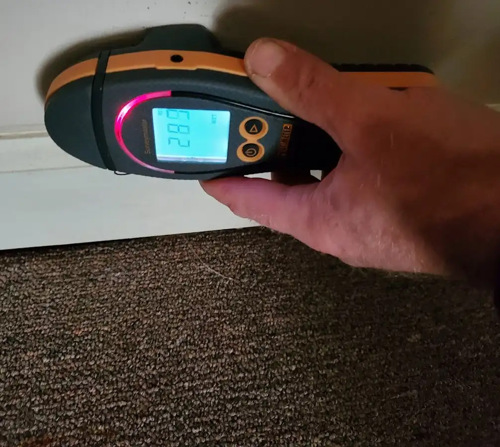 Moisture detection at baseboard during Burst Pipe Cleanup in East Camden